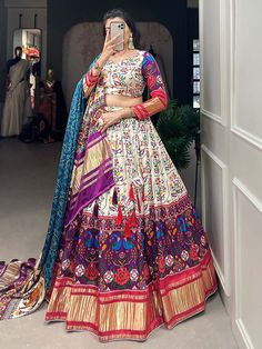 This stunning white & purple gaji silk lehenga is adorned with intricate digital print and lagadi patta work. Paired elegantly with a matching gaji silk choli featuring identical digital print and lagadi patta work, and complemented by a striking blue gaji silk dupatta embellished with digital print work and lagdipatta work, complete with tassels on both sides, this ensemble exudes sophistication and charm.
The combination of white and purple hues, combined with the intricate digital print a Multicolor Digital Print Lehenga For Wedding, Multicolor Semi-stitched Digital Print Choli, Multicolor Choli With Digital Print And Traditional Drape, Multicolor Semi-stitched Lehenga With Digital Print, Anarkali Choli With Digital Print, Multicolor Semi-stitched Digital Print Lehenga, Multicolor Digital Print Semi-stitched Lehenga, Multicolor Digital Print Choli For Festivals, Purple Meenakari Lehenga For Navratri