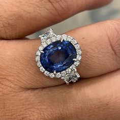 An enviable jewel, this ring sports some dazzling Diamonds & a sparkling Sapphire. Gemstones Type: Sapphire Gemstones Shape: Oval Gemstones Weight: 5.92 ctGemstones Color: Blue Diamonds Shape: Round & Radiant Side Diamonds Weight: 1.75 ct Side Diamond Color: F - G Side Diamond Clarity: VS (Very Slightly Included) Metal: 18K White Gold Metal Wt: 4.3 gms Setting: Prong & Pave Finger Size: 7 To have the ring sized, please note the desired size in Special Instructions during checkout. Luxury Gia Certified Platinum Gemstones, Luxury White Gold Gia Certified Gemstones, Luxury Gia Certified White Gold Gemstones, Luxury Gia Certified Diamond Gemstones, Luxury Sapphire Cluster Ring With Brilliant Cut, Gia Certified Platinum Gemstones Fine Jewelry, Luxury Brilliant Cut Platinum Gemstones, Luxury Gia Certified Gemstones, Luxury Cushion Cut Sapphire Ring With Vvs Clarity