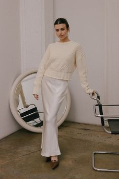 The Valeria Skirt is a satin maxi skirt. It features a bias cut and mermaid line enhancing the silhouette, while the elastic waistband provides a comfortable fit. 100% Polyester Cream Outfits, Satin Maxi Skirt, Cropped Crewneck, Sweater Crop, Elegant Blouses, Satin Maxi, Shoulder Design, Sweater Skirt, Formal Occasion