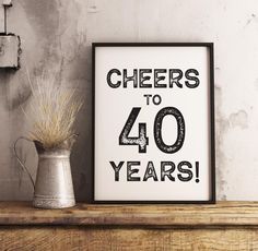 there is a sign that says cheers to 40 years on it next to a potted plant