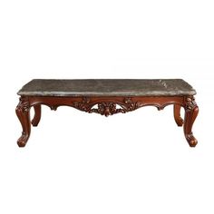 an ornate wooden table with marble top