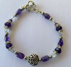 Amethyst crystal beads for February birthdays.  Add the antique looking puffed heart and the heart toggle clasp for 7 1/4 inches of lovely gift. February Birthday, Puffed Heart, Amethyst Bracelet, Silver Accents, Toggle Clasp, Amethyst Crystal, Lovely Gift, Crystal Beads, Antique Silver