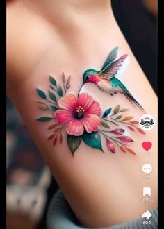 the tattoo is decorated with flowers and birds