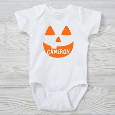 * Personalized with any name * Choice of Jack-o'-Lantern character and colors  * Features double-needle ribbed binding on neck, shoulders, sleeves and legs * Reinforced 3 snap closure * Available in infant 6 months - 18 months * 100% combed ring-spun cotton jersey * Machine wash, tumble dry * Not intended for sleepwear * Imported Our Jack-o'-Lantern Personalized Halloween Baby Clothing will make for great pictures at the pumpkin patch or Halloween parties. Outfit your entire family in our Skelet Fall Playtime Fitted Bodysuit, Fitted Bodysuit For Playtime In Fall, White Onesie Halloween Costume, Fitted White Onesie For Fall, White Bodysuit For Halloween Costume Party, Fitted White Bodysuit With Character Print, Fitted Halloween Onesie For Playtime, Fitted Onesie For Halloween Playtime, Cute White Bodysuit For Halloween