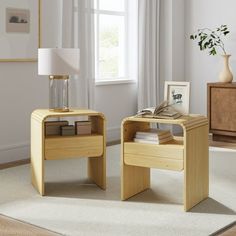 two wooden tables sitting on top of a carpeted floor next to a lamp and window