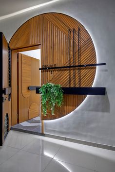 a plant is growing in the center of a circular wall decoration with wood panels and metal bars