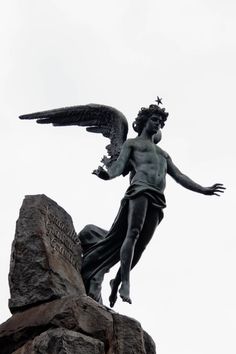 an angel statue on top of a rock