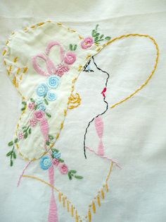 a white shirt with embroidery on it and a woman's face in the center