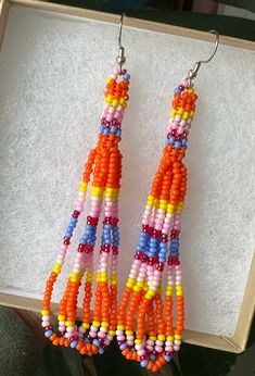 Orange petite stitch beaded earrings. Earrings measure 3 inches.  *made by a local artist* Unique Orange Beaded Earrings, Unique Orange Beaded Earrings With Colorful Beads, Adjustable Orange Tiny Beads Earrings, Unique Multicolor Beaded Earrings, Multicolor Beaded Chain Earrings As Gift, Multicolor Beaded Chain Earrings For Gift, Orange Beaded Earrings With Tiny Round Beads, Beaded Jewelry Diy, Jewelry Diy