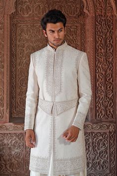 Pearl sherwani with floral embroidered motifs paired with flared inner kurta. Comes with churidar and embroidered kamarband.
Components: 4
Fabric: Raw Silk
Neckline: Mandarin
Sleeve Length: Full
Color: White
Embroidered

Floral motif work
Flared kurta
Embroidered kamarband - Aza Fashions Luxury Chikankari Embroidered Sherwani For Party, Luxury Jamawar Sherwani With Chikankari Embroidery, Luxury White Sherwani For Puja, Luxury White Sherwani With Pearl Embroidery, Luxury Brocade Sherwani With Intricate Embroidery, Luxury Off-white Traditional Sherwani, Embroidered Traditional Fit Sherwani For Eid, Eid Raw Silk Sherwani With Intricate Embroidery, Eid Sherwani With Intricate Embroidery In Raw Silk