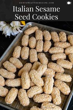 italian sesame seed cookies on a cooling rack with flowers in the background and text overlay