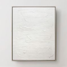 a white square painting hanging on the wall