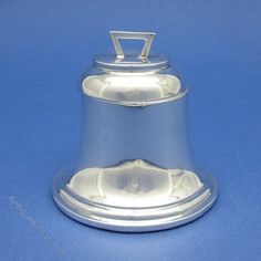 a silver bell on a blue background with clippings to the top and bottom