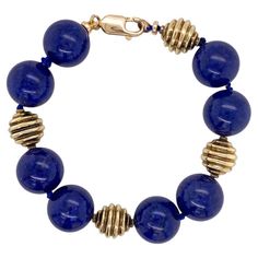 Bold in size and rich in color, these large lapis lazuli beads are 10.5 mm in size and accented with 18 karat yellow gold beads on this fabulously versatile bracelet. The large size makes a statement that looks wonderful whether you're dressing up or down! Lapis lazuli is a deep blue stone speckled with rich sparkles, like a night sky full of stars. Lapis lazuli has been associated with strength and courage, royalty and wisdom, intellect and truth. From antiquity, lapis lazuli has been worn in t Blue Lapis Lazuli Jewelry With Large Beads, Polished Beads Lapis Lazuli Round Bracelets, Blue Lapis Lazuli Beaded Bracelets With Polished Beads, Polished Beads Lapis Lazuli Bracelets, Lapis Lazuli Beaded Bracelets With Polished Round Beads, Round Lapis Lazuli Bracelets With Polished Beads, Blue Lapis Lazuli Bracelets With Polished Beads, Lapis Lazuli Polished Beads Bracelet, Formal Lapis Lazuli Jewelry With Round Beads