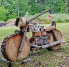 an old wooden tractor is sitting in the grass