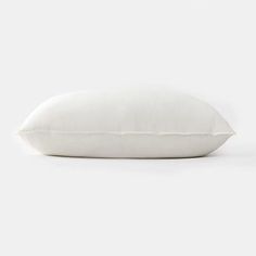 a white pillow on a white background with no one in the photo to describe it