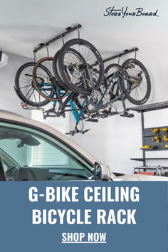 two bikes hanging from the ceiling in a garage