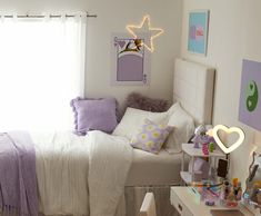 a bedroom with white walls and purple accents