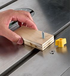 a person using a router to cut wood on a piece of metal with a screwdriver