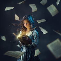 a woman reading a book surrounded by flying papers