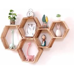 four hexagonal shelves with various toy animals and plants on them, all made out of wood