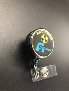 This unique retractable badge holder is adorable and useful. A great gift for any Radiation Therapist! These will be made with a belt clip back. If you prefer a swivel clip, let me know in the notes to seller section when checking out. Thank you!! :) Black Retractable Badge Holders As Gift, Adjustable Black Retractable Badge Holder, Black Adjustable Retractable Badge Holders, Black Retractable Badge Reel For Gift, Black Badge Reel With Swivel Clip As A Gift, Radiation Therapist Gifts, Radiation Therapist, Xray Tech, Retractable Badge Holder