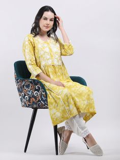 Latest Style Indian Designer Embroidered Cotton A- line Kurta Elevate your ethnic wardrobe with this exquisite Women's Yellow Floral Printed Cotton A-Line Chikankari Embroidered Kurta. This stunning kurta seamlessly blends traditional charm with contemporary style, making it a versatile addition to your collection. Adorned with a beautiful floral print, this kurta features intricate Chikankari embroidery that showcases timeless craftsmanship. The delicate patterns and vibrant hues add a touch of Traditional Bandhani Print Sets For Spring, Spring Anarkali Kurta With Bandhani Print, Spring Straight Kurta With Embroidered Border, Straight Kurta With Embroidered Border For Spring, Spring Embroidered Straight Kurta, Summer Traditional Wear With Printed Motifs In Mulmul, Bohemian Traditional Wear With Chikankari Embroidery For Spring, Cotton Kurta With Yoke For Navratri, Spring Cotton Traditional Wear With Embroidered Border