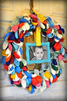 a colorful wreath with a photo hanging on the front door