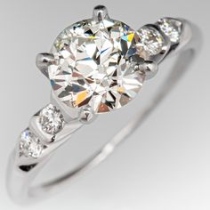 This gorgeous vintage engagement ring is centered with a round old European cut diamond, weighing 1.02 carats, in a four-prong setting. The shoulders are each partially bezel set with two (2) round brilliant cut diamonds. The ring measures 6.8mm at the top, rises 6.5mm above the finger, tapering to 0.5mm wide and 0.9mm thick at the base of the shank. The ring is currently a size 4.5 and we offer complimentary resizing to fit. Gia Certified Vintage Ring With Round Band, Vintage Diamond Ring With Brilliant Cut, Vintage Diamond Ring With Brilliant Round Cut, Vintage Brilliant Cut Round Diamond Ring, Vintage Brilliant Cut Diamond Ring, Vintage Gia Certified Diamond Ring With Round Band, Vintage Gia Certified Diamond Ring, Classic Diamond Ring With Single Cut Round Stone, Vintage Gia Certified Round Cut Rings