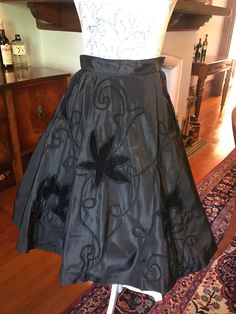 "Stunning 1950s skirt with velvet flowers on the front. An absolute delight to wear. Great in the office or out at drinks.  Measurements  Waist: 13\" Hip: free No flaws" Elegant Floral Embroidered Party Skirt, Fitted Full Skirt With Floral Embroidery, Spring Formal Embroidered Skirt, Embroidered Flared Skirt For Party, Retro A-line Skirt For Party, Vintage Formal Flared Skirt, Vintage Flared Formal Skirt, Vintage Flared Skirt For Formal Occasions, Elegant Embroidered Party Skirt