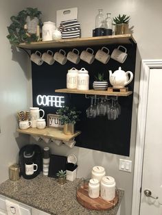 a coffee bar with cups, mugs and other items on the shelves above it