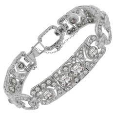 A true treasure from the Art Deco era, circa 1930, this bracelet features approximately 16 carats of diamonds set in lovely patterns around open platinum work. Five of the largest diamonds on the bracelet weigh over 1 carat each! The diamond settings are finished with hand applied millgrain in traditional deco fashion. Hand-fabricated in platinum, a fine Art Deco diamond bracelet worth of any collection. Length: 7 inches Art Deco Diamond Jubilee Bracelet, Vintage Diamond Bracelet With Hand-set Diamonds, Vintage Hand Set Diamond Bracelet, Art Deco Diamond Tennis Bracelet With Brilliant Cut, Art Deco Platinum Tennis Bracelet With Diamond Accents, Art Deco Diamond Tennis Bracelet With Single Cut Diamonds, Vintage White Gold Diamond Bracelet With Brilliant Cut, Art Deco Platinum Diamond Bracelet, Formal Art Deco Diamond Tennis Bracelet