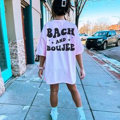 a woman is walking down the sidewalk wearing a t - shirt that says back and bounce