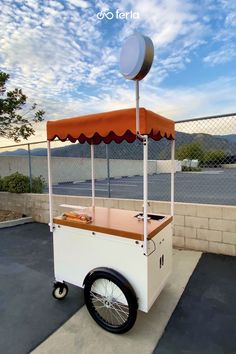 an ice cream cart is parked on the sidewalk