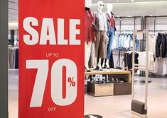 the sale sign is up to 70 % off in this department's clothing store