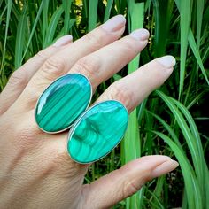 Two one-of-a-kind large Malachite rings set in simple sterling silver settings. Open back setting to show off the back of the stone. Double ring band for comfort. Open band setting so the ring will sit flush on your finger and not flop around.  Both are set on size 9 ring bands 0.925 sterling silver Stone #1 is slightly larger: 1.5"x 1" Stone #2 is: 1.35" x 0.85" Malachite is a stone of joy and ease during times of change and transformation.  It is even said to absorb pain. Modern Green Jewelry With Large Stone, Modern Sterling Silver Emerald Ring, Green Polished Sterling Silver Gemstones, Green Sterling Silver Gemstones With Polished Finish, Modern Sterling Silver Green Rings, Green Sterling Silver Minimalist Ring, Sterling Silver Rings With Large Green Stone, Sterling Silver Ring With Large Green Stone, Modern Oval Sterling Silver Gemstones