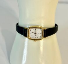 Elegant vintage Hamilton gold-filled watch with a soft, delicate black leather band. This watch is in excellent condition. This is a beautiful example of a 1950s Hamilton wind watch. It does not need a battery, but you will need and set each time you wear it. The watch is over 8 inches long and is adjustable to approximately 6 inches. It's a very comfortable fit and goes with pretty much everything. I have carefully cleaned the watch case and conditioned the leather in the band. It has been running consistently and on time for several weeks now.  Customized gift wrapping is available for a small additional fee. Shipping is free! Cheap Vintage Formal Watch, Cheap Vintage Formal Watches, Vintage Black Watch For Formal Occasions, Black And Gold Watch, Ladies Dress Watches, Black Leather Watch, Sweet Earrings, Ladies Dress, Leather Watch Bands