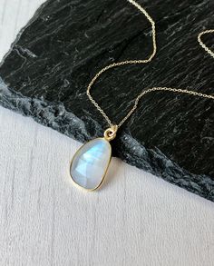 Rainbow Moonstone Necklace, Solid 14k Gold Pendant, June Birthstone, Real Gold Moonstone Jewelry , Birthday gift for her, Mother's Day Gift This classic minimalist necklace features a beautiful flashy rainbow moonstone free form pendant bezeled in solid 14k gold. The moonstone pendant is suspended from a dainty solid 14k gold cable chain that can adjust to three popular lengths, 16, 17 or 18 inches, whenever you needed. This is a slightly larger version of one of our best sellers for those that Yellow Gold Moonstone Jewelry With Birthstone, Yellow Gold Moonstone Gemstone Jewelry, Moonstone Round Pendant Jewelry For Gift, Gift Necklace With Large Oval Stone, Oval Necklace With Large Stone For Gifts, Gift Necklace With Large Round Stone, Moonstone Birthstone Pendant Necklaces, Moonstone Round Necklace For Anniversary, Teardrop Necklace With Moon Charm As Gift