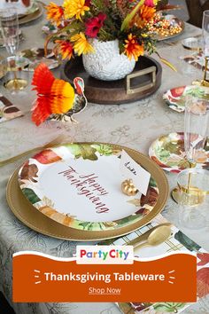 a thanksgiving table setting with place settings, plates and napkins for dinner party city