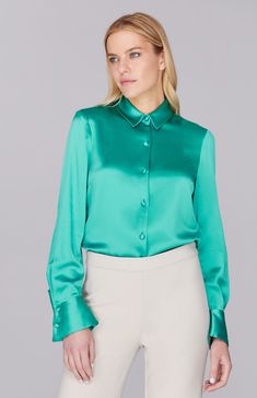 Our signature collared button down shirt is an elegant update to a wardrobe staple. Cut with a beautifully drapey and relaxed sleeve and finished with a wide angled cuff that can be worn long or folded up for maximum versatility. An easy way to add a pop of color and shine under a jacket, but strong enough to stand alone. Preppy Blouses, Satin Pajama Pants, Green Shirts, Evening Jackets, Satin Blouses, Pajama Pant, Satin Pajamas, Satin Blouse, Pleated Pants