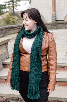 a woman wearing a green scarf and leather jacket