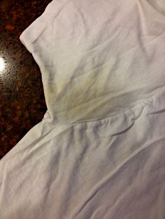 a white shirt laying on top of a table