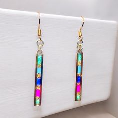 **Gold Plated Handmade Resin Earrings - One of a Kind Dainty Elegance** Hello and welcome to Erin's Emporium! I'm Erin, and I'm thrilled to introduce you to my Gold Plated, Handmade, Long, Rectangular, Multi-Coloured, Delicate and Dainty 1 of a Kind Earrings. These earrings are close to my heart, designed with love and care for women who appreciate the unique charm of handcrafted jewellery. 🌟 **Why These Earrings Are Special Every pair of these resin earrings is a unique creation. I've poured m Vibrant Colorful Earrings For Gifts, Colorful Earrings As A Gift, Vibrant Rainbow Drop Earrings, Rainbow Drop Earrings As A Gift, Colorful Drop Earrings As A Gift, Vibrant Drop Earrings Jewelry Gift, Rainbow Drop Earrings For Party, Vibrant Drop Earrings For Gifts, Vibrant Drop Earrings For Gift