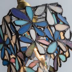 a multicolored glass lamp hanging from a light fixture