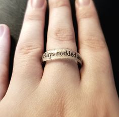 a woman's hand with a ring that says, filthy noddera