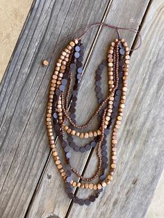 This beautiful handmade multi strand necklace with wood & resin beads will add the perfect touch to your bohemian look. One size fits all. Product Dimensions: Approximately 34" long adjustable Wood Bead Necklace, Bohemian Look, Wood Resin, Resin Beads, Coffee Bean, Multi Strand Necklace, Strand Necklace, Boho Necklace, Multi Strand