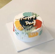 a birthday cake with the words happy on it sitting on top of a white table