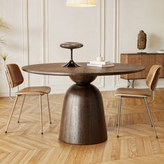 a wooden table with two chairs around it