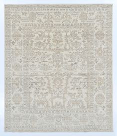 an antique rug with many different colors and patterns on the carpet, including beiges and browns