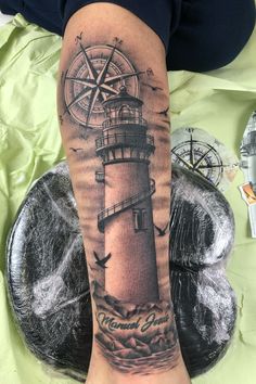 a person with a lighthouse tattoo on their leg